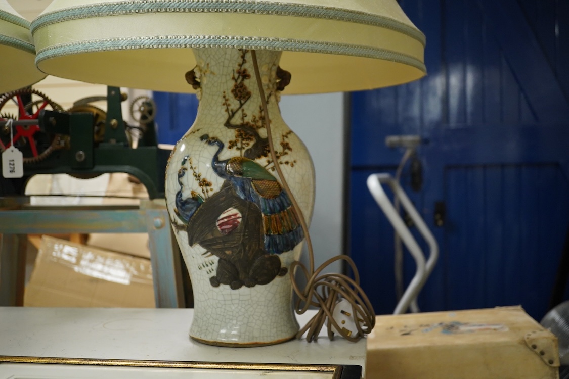A large pair of early 20th century Chinese crackle glaze vases, mounted as table lamps, eac decorated in relief with peacocks, overall 80cm high